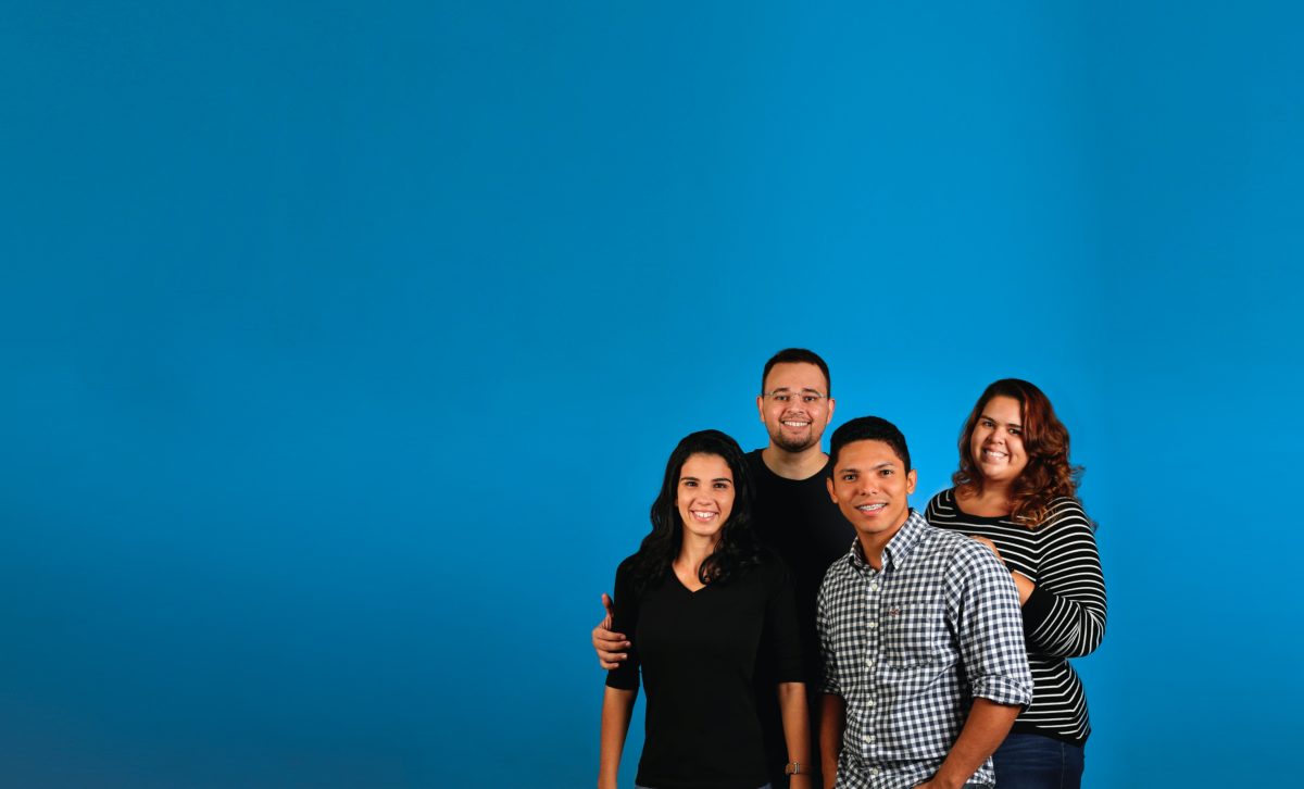 Group of 4 people on blue background. Team building.