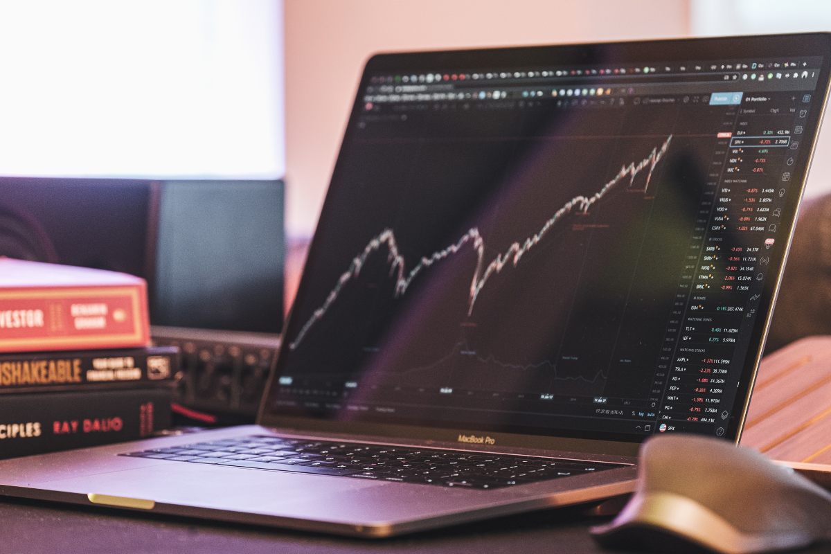 Business trends with Joel Block: laptop screen with undulating graph showing gains and losses