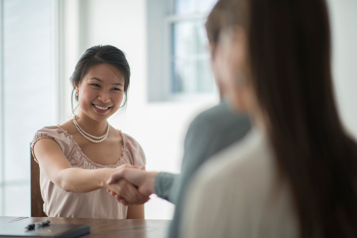 K-economy: women shaking hands with a man